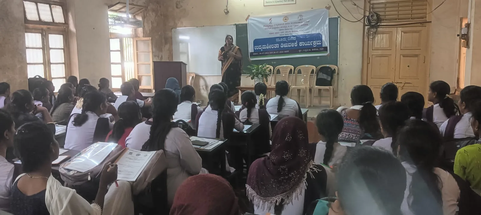 Mrs. Rita Marshall addressing a classroom of college students during an entrepreneurship awareness program