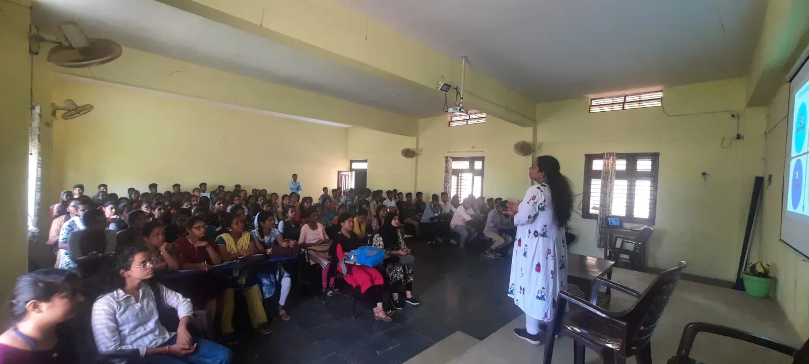Mrs. Rita Marshall conducting a large-audience employability training session for students at a college hall